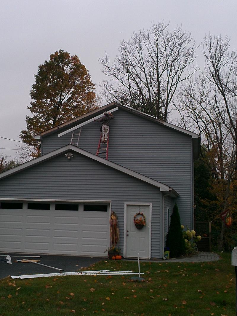 Replacing facia boards that blew down in a storm.